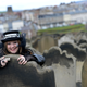 A woman poses for photographs during the Goth festival in Whitby, northern England April 28, 2013. The Goth culture emerged from the Punk scene in the 1980's, developing its own music and fashion styles. The festival in Whitby is now in it's 19th year and attracts around ten thousand people over the weekend.